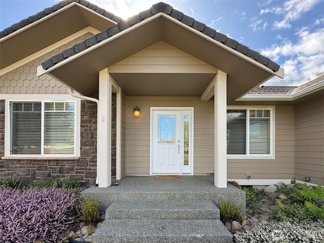 property entrance with stone siding