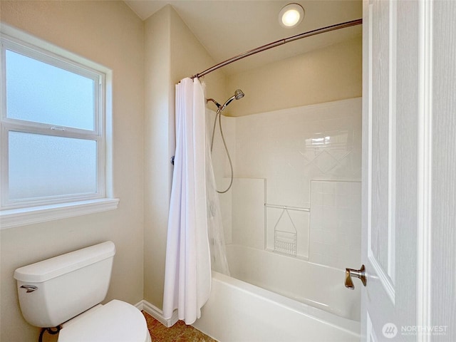bathroom with toilet, baseboards, and shower / tub combo with curtain