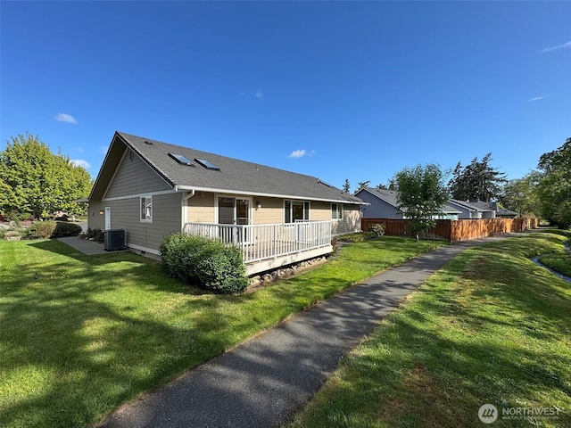 view of side of home featuring a deck and central AC