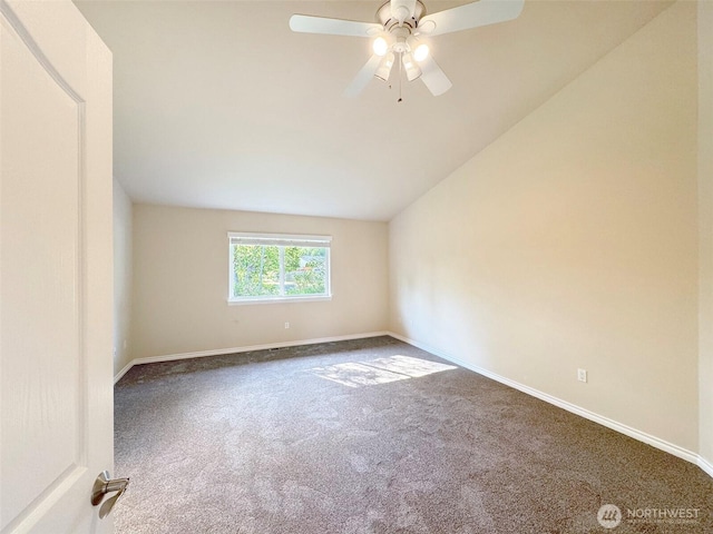 carpeted empty room featuring vaulted ceiling, baseboards, and ceiling fan