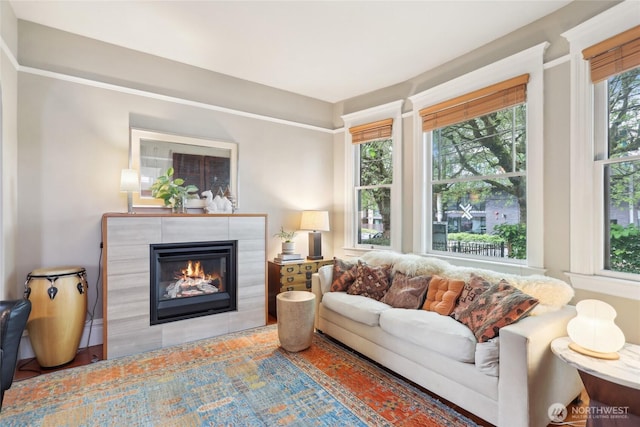 living room featuring a tiled fireplace