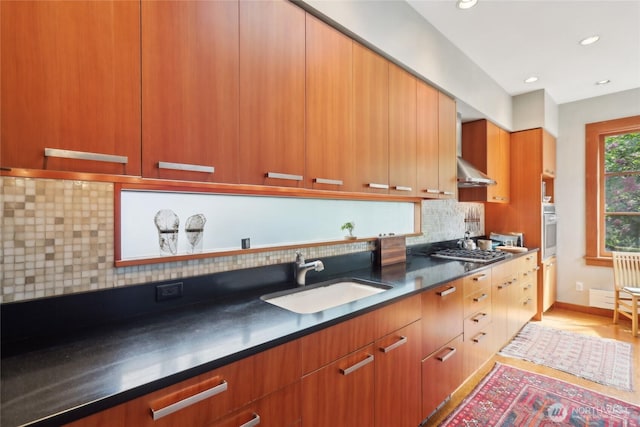 kitchen featuring a sink, oven, dark countertops, modern cabinets, and decorative backsplash