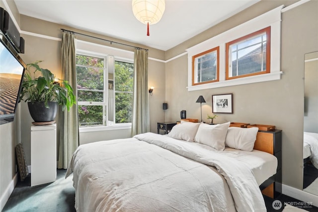 carpeted bedroom with baseboards
