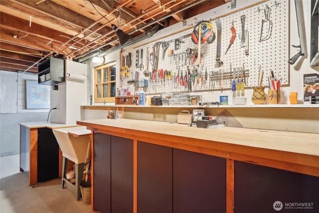 unfinished basement featuring a workshop area