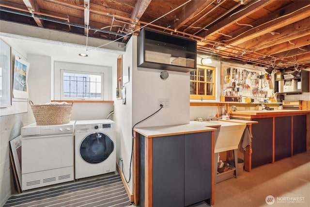 clothes washing area with washing machine and clothes dryer and carpet floors