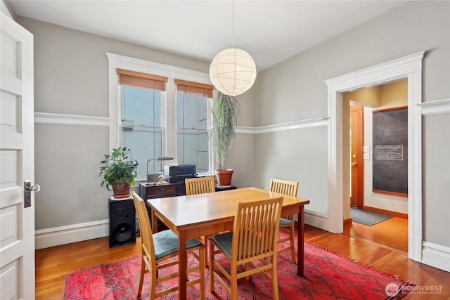 dining space with wood finished floors and baseboards
