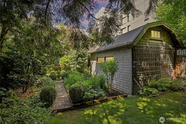 property exterior at dusk featuring a yard
