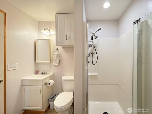 full bath with a stall shower, vanity, toilet, and recessed lighting