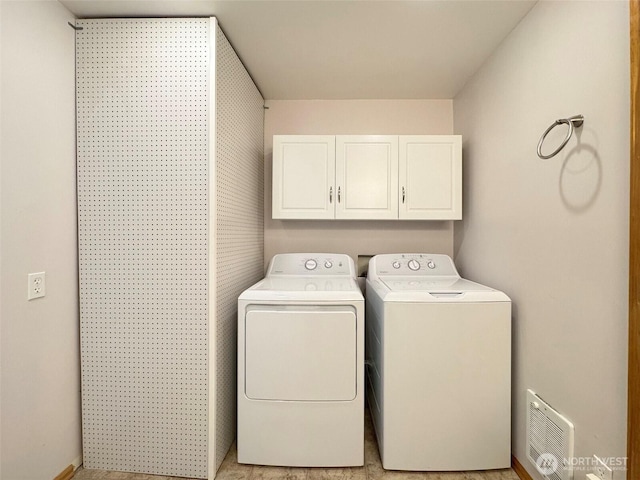 laundry room featuring cabinet space and independent washer and dryer