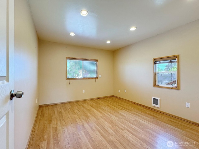 unfurnished room featuring light wood-type flooring, recessed lighting, and baseboards
