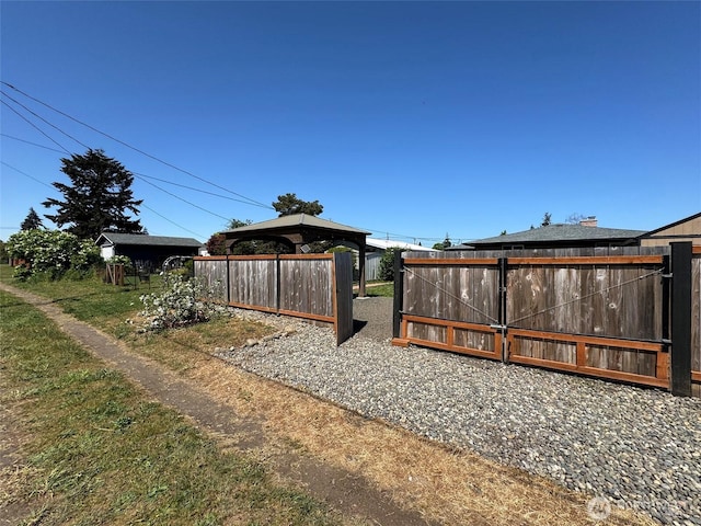 view of yard with fence and a gazebo