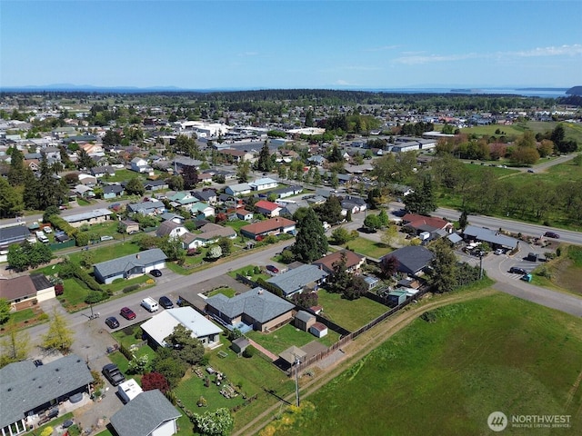 aerial view of property and surrounding area featuring nearby suburban area