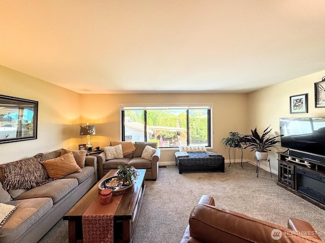 carpeted living room featuring baseboards