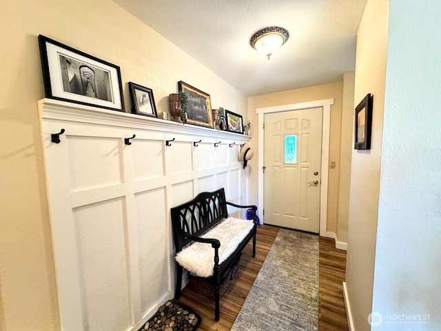 mudroom featuring dark wood-style flooring and baseboards