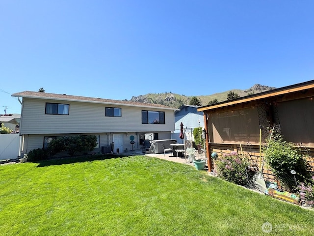 rear view of property with a patio and a mountain view