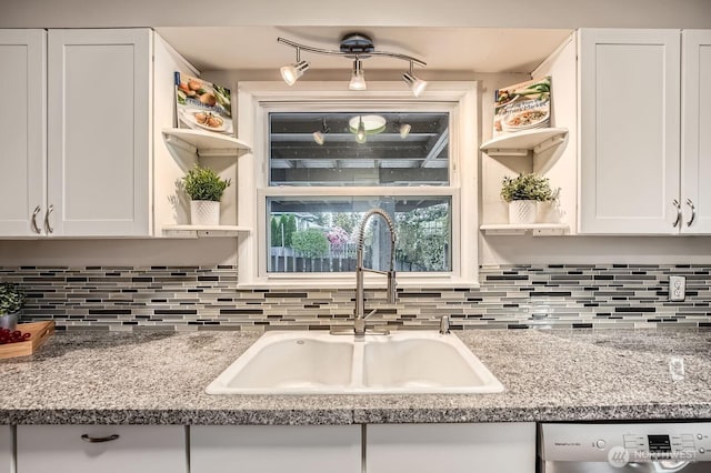 kitchen featuring open shelves, a sink, white cabinetry, tasteful backsplash, and dishwasher