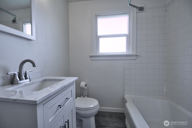 819 Decatur St SW, Olympia, WA 98502 - full bathroom featuring toilet, wood finished floors, vanity, tub / shower combination, and baseboards