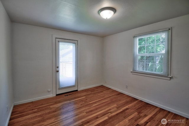 819 Decatur St SW, Olympia, WA 98502 - spare room with baseboards, a healthy amount of sunlight, and wood finished floors