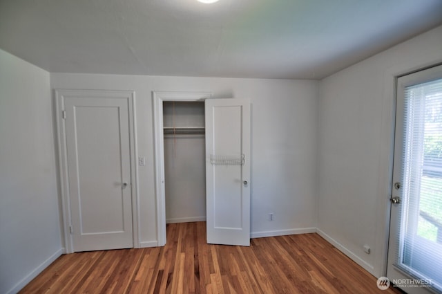 819 Decatur St SW, Olympia, WA 98502 - unfurnished bedroom featuring baseboards, a closet, and wood finished floors
