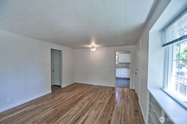 819 Decatur St SW, Olympia, WA 98502 - spare room featuring baseboards, visible vents, and wood finished floors