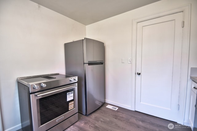 819 Decatur St SW, Olympia, WA 98502 - kitchen featuring baseboards, visible vents, white cabinetry, dark wood-type flooring, and appliances with stainless steel finishes
