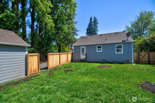 819 Decatur St SW, Olympia, WA 98502 - rear view of house featuring a shingled roof, a yard, crawl space, and a fenced backyard