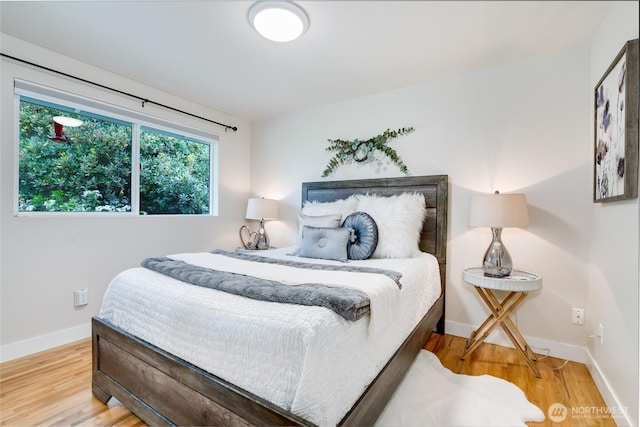 bedroom with wood finished floors and baseboards