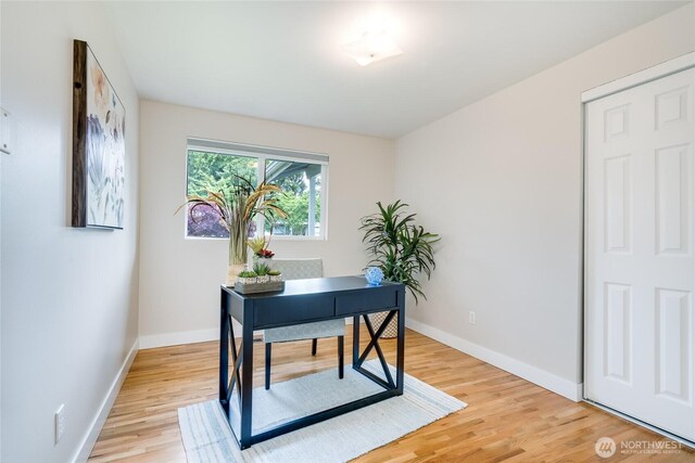 office with light wood-style flooring and baseboards