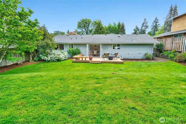rear view of house with a wooden deck