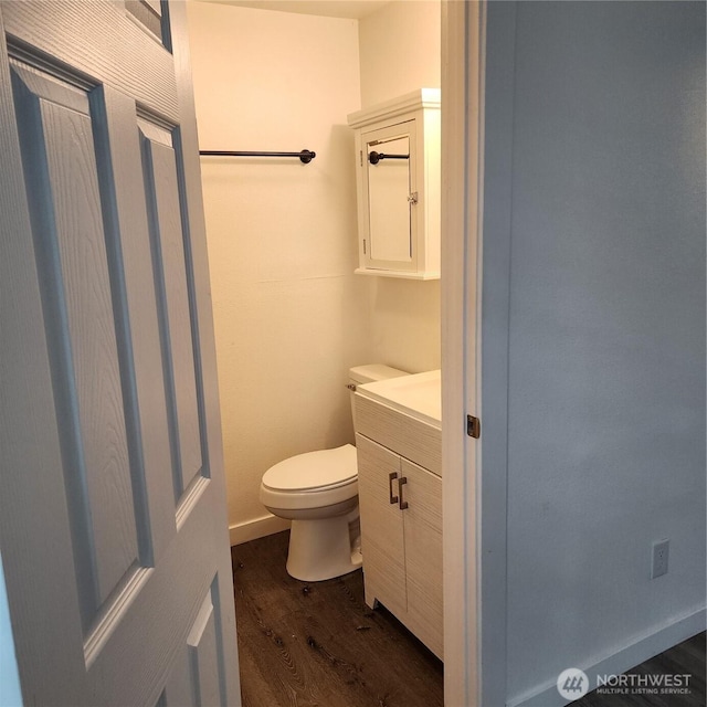 705 E 54th St, Tacoma, WA 98404 - bathroom with wood finished floors, toilet, and vanity