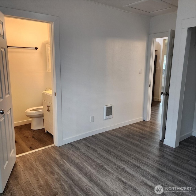 705 E 54th St, Tacoma, WA 98404 - unfurnished bedroom featuring dark wood-type flooring, baseboards, and connected bathroom