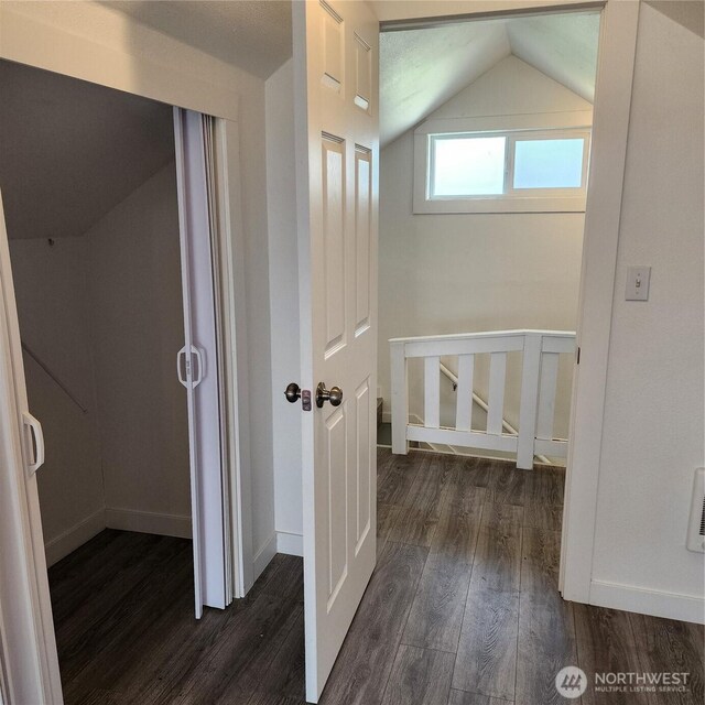 705 E 54th St, Tacoma, WA 98404 - corridor with dark wood-type flooring, vaulted ceiling, and baseboards