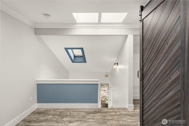 716 W Argand St Unit C, Seattle, WA 98119 - stairway with a skylight, ornamental molding, wood finished floors, and baseboards