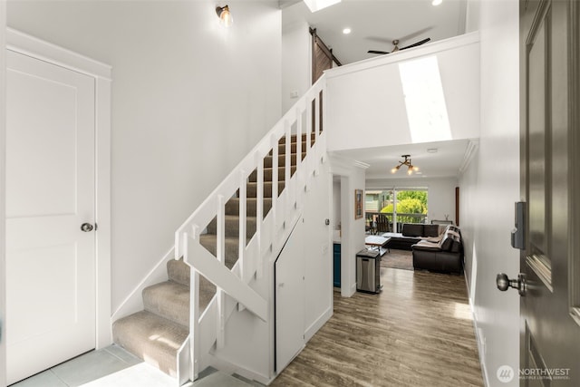 716 W Argand St Unit C, Seattle, WA 98119 - stairs with wood finished floors, crown molding, recessed lighting, and a towering ceiling