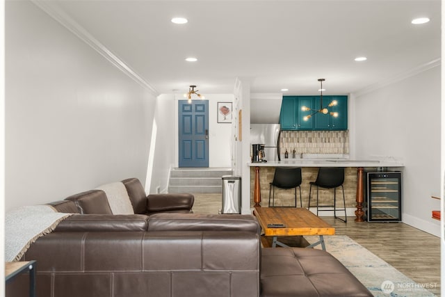 716 W Argand St Unit C, Seattle, WA 98119 - living room with beverage cooler, crown molding, wood finished floors, recessed lighting, and baseboards