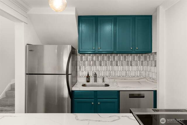 716 W Argand St Unit C, Seattle, WA 98119 - kitchen with appliances with stainless steel finishes, a sink, light stone counters, and backsplash