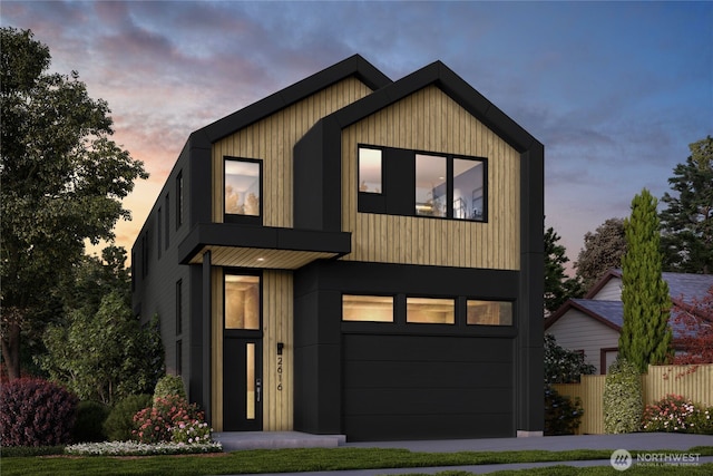 view of front of home featuring fence and an attached garage
