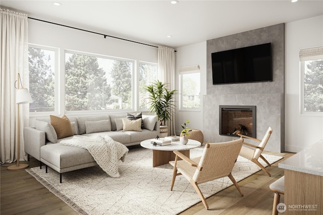 living room with recessed lighting, wood finished floors, and a fireplace