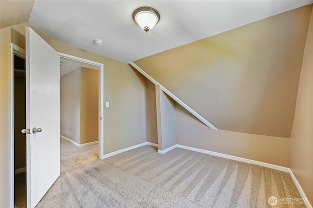 additional living space with lofted ceiling, carpet, and baseboards