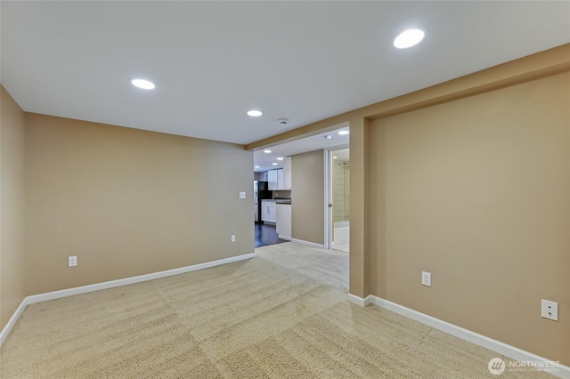 empty room featuring baseboards, light colored carpet, and recessed lighting