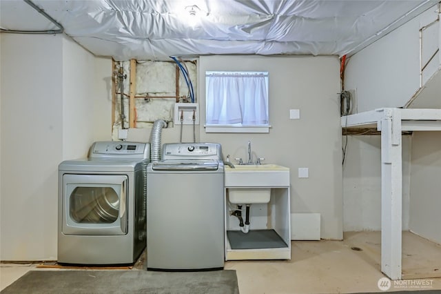 clothes washing area featuring washer and dryer