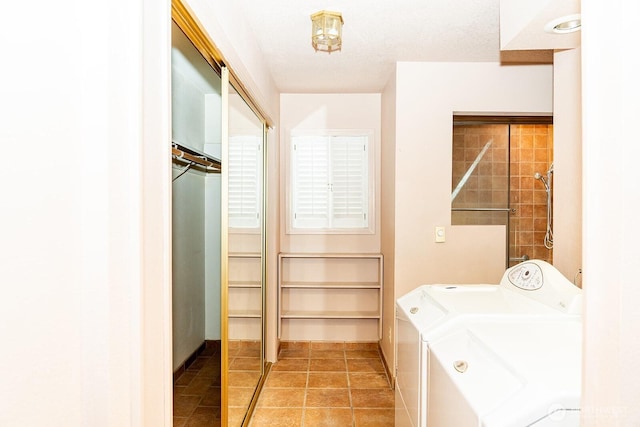 washroom featuring washer and dryer and tile patterned flooring