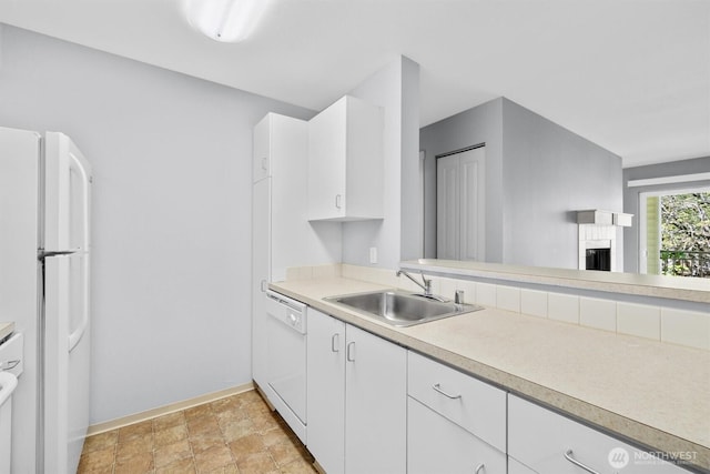 12303 Harbour Pointe Blvd Unit U202, Mukilteo, WA 98275 - kitchen featuring a sink, white appliances, light countertops, baseboards, and white cabinetry