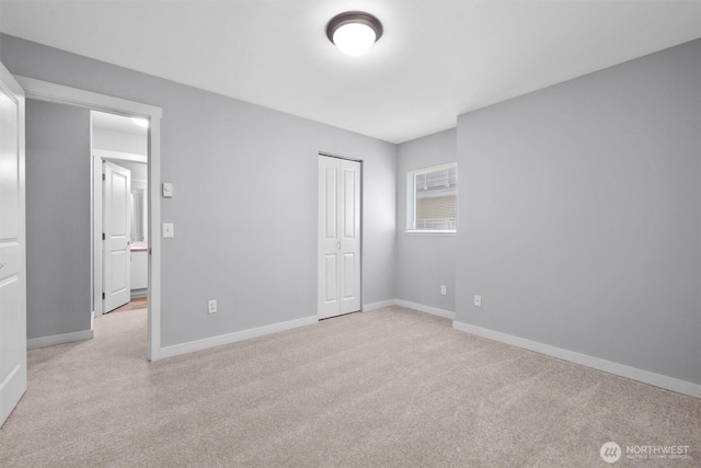12303 Harbour Pointe Blvd Unit U202, Mukilteo, WA 98275 - unfurnished bedroom featuring light colored carpet, a closet, and baseboards