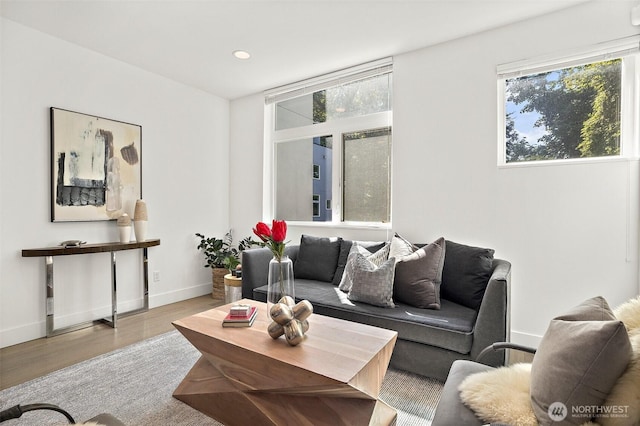 living room with plenty of natural light, wood finished floors, baseboards, and recessed lighting