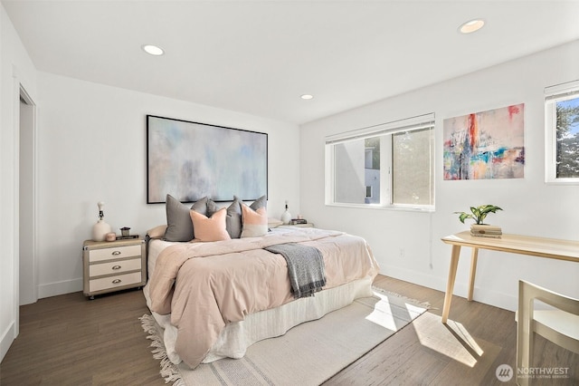 bedroom featuring wood finished floors, baseboards, and recessed lighting