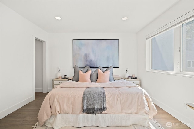 bedroom featuring wood finished floors, baseboards, and recessed lighting