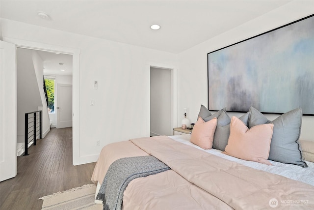 bedroom with wood finished floors, baseboards, and recessed lighting