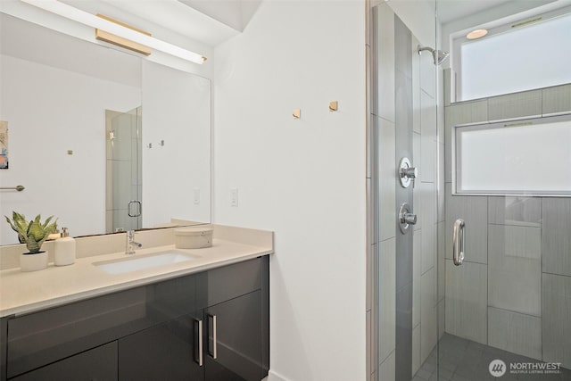 bathroom with a shower stall and vanity