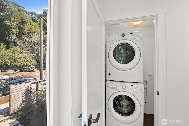 laundry area with stacked washing machine and dryer